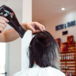 “건강한 헤어케어, 일상에서 시작하세요…지속가능한 뷰티 트렌드로 자리잡아” woman in white shirt holding hair blower