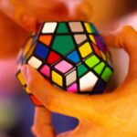 “뇌 건강, 생활 속 작은 변화로 지킨다”…집콕 시대 실천하는 두뇌 관리법 person holding 3 x 3 rubiks cube